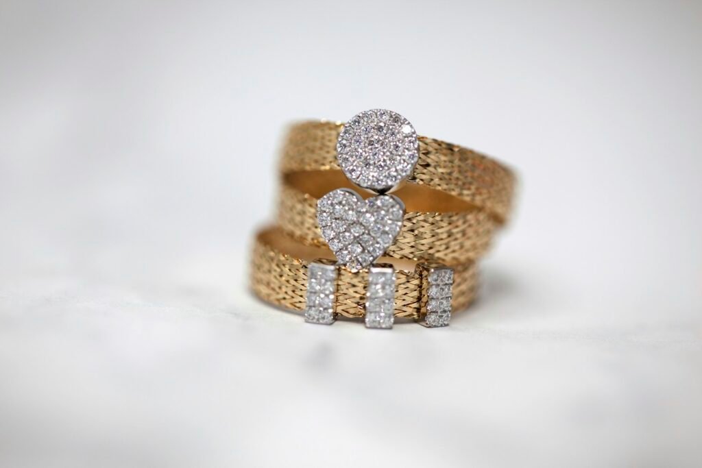 Three gold rings set with clear stones