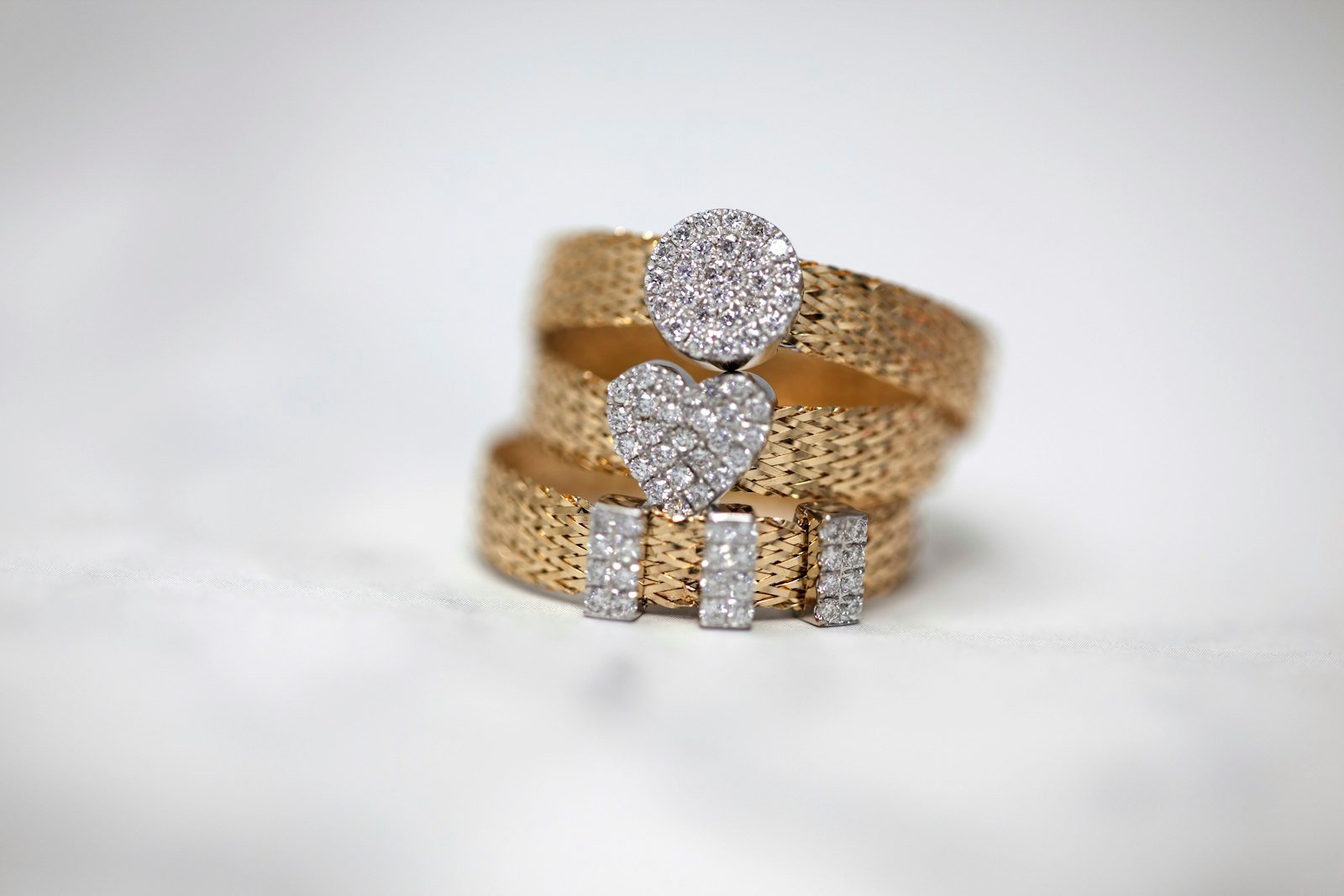 Three gold rings set with clear stones