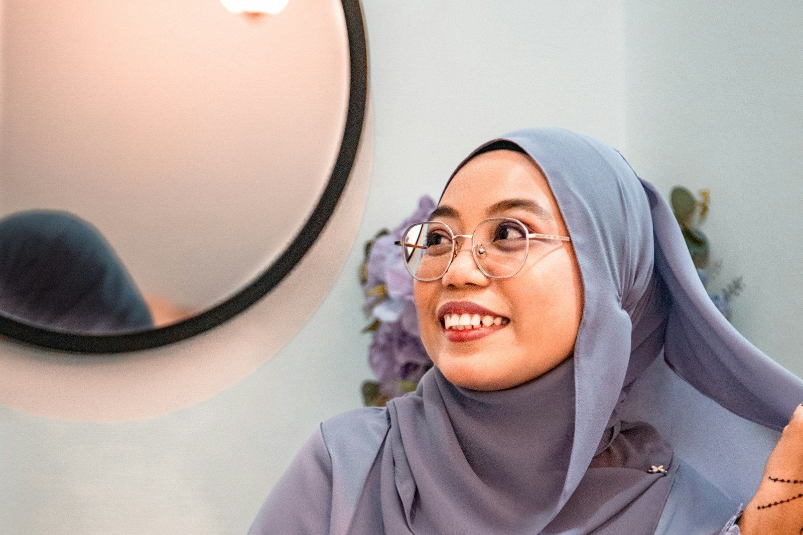 Smiling woman adjusting her hijab