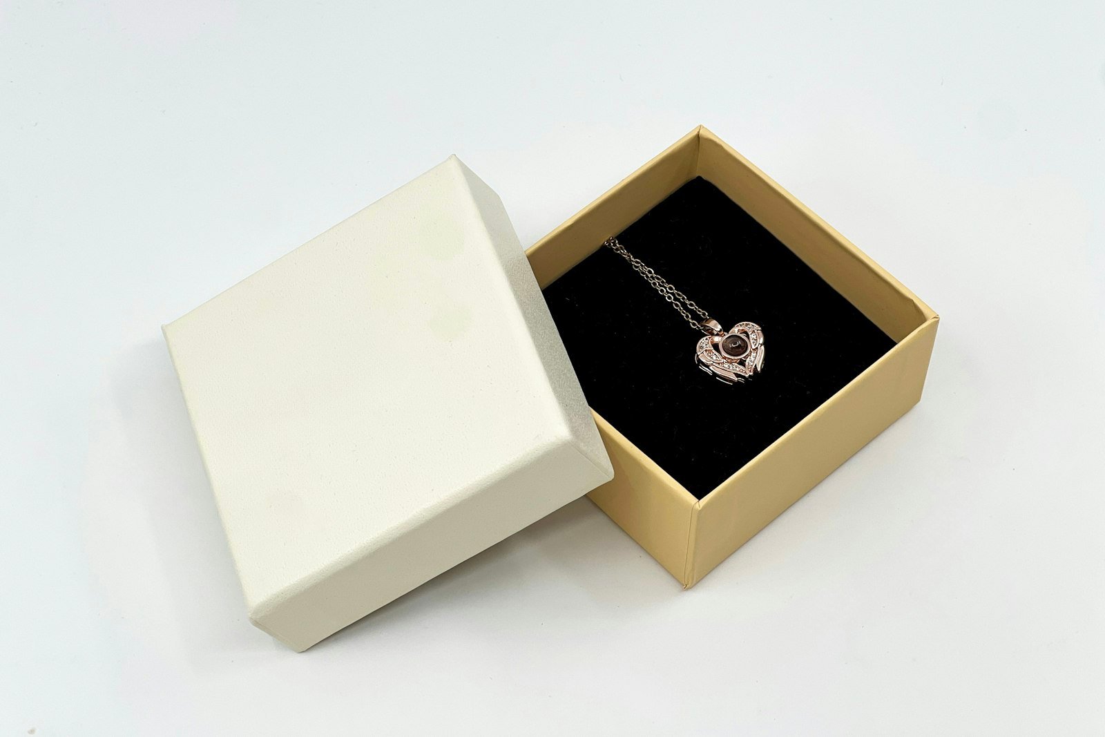 Heart pendant necklace in an open ivory gift box