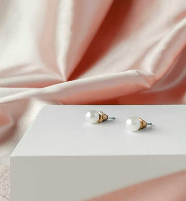 Pearl earrings on a white gift box