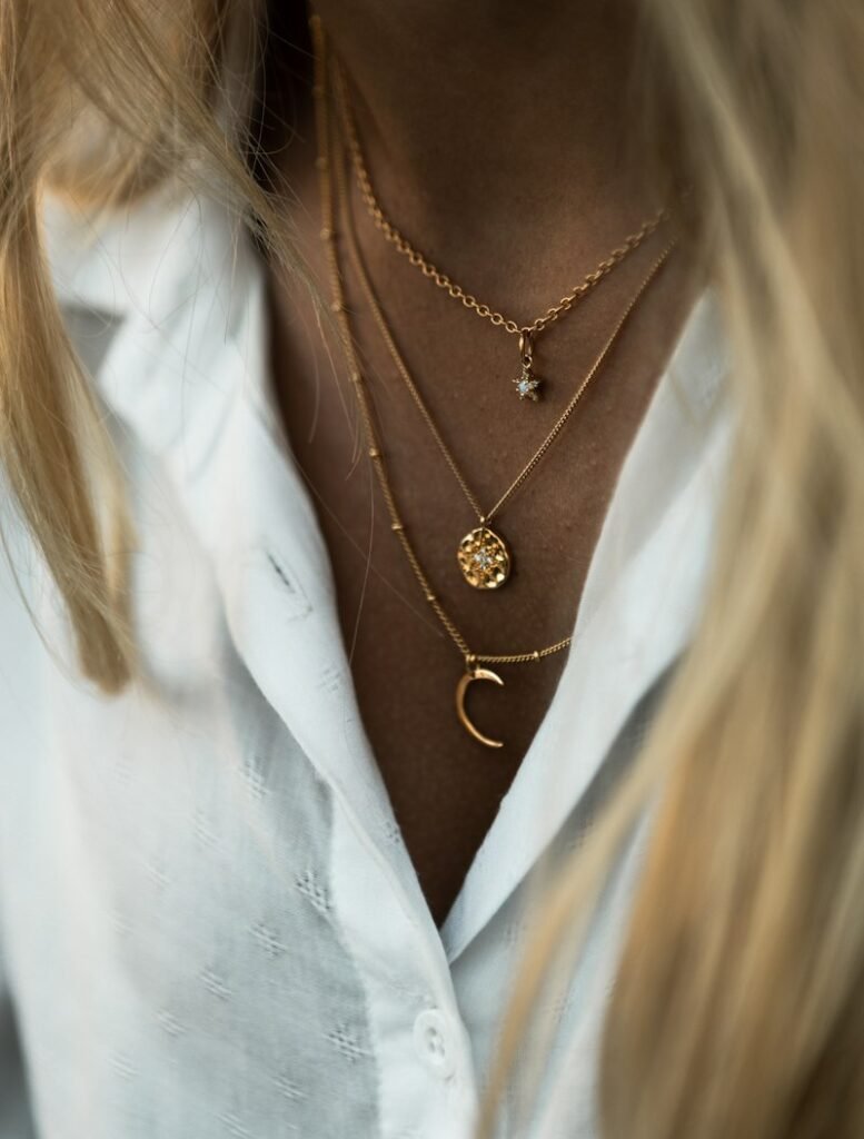Three layered gold necklaces on the neck
