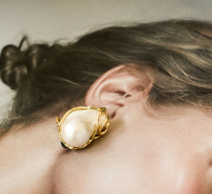 Close-up of a pearl earring on the ear