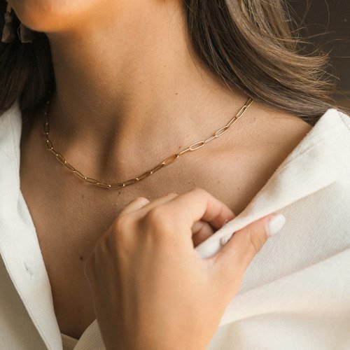 Gold necklace worn with a white shirt